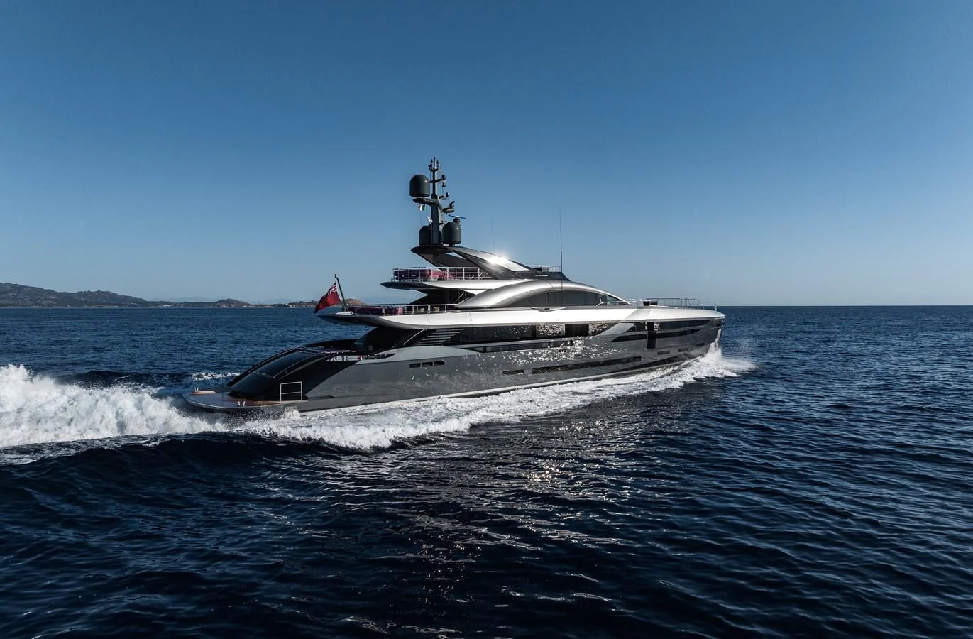 A sleek and modern yacht cruises through the open sea under a clear blue sky. aboard FLYING DAGGER III Yacht for Sale