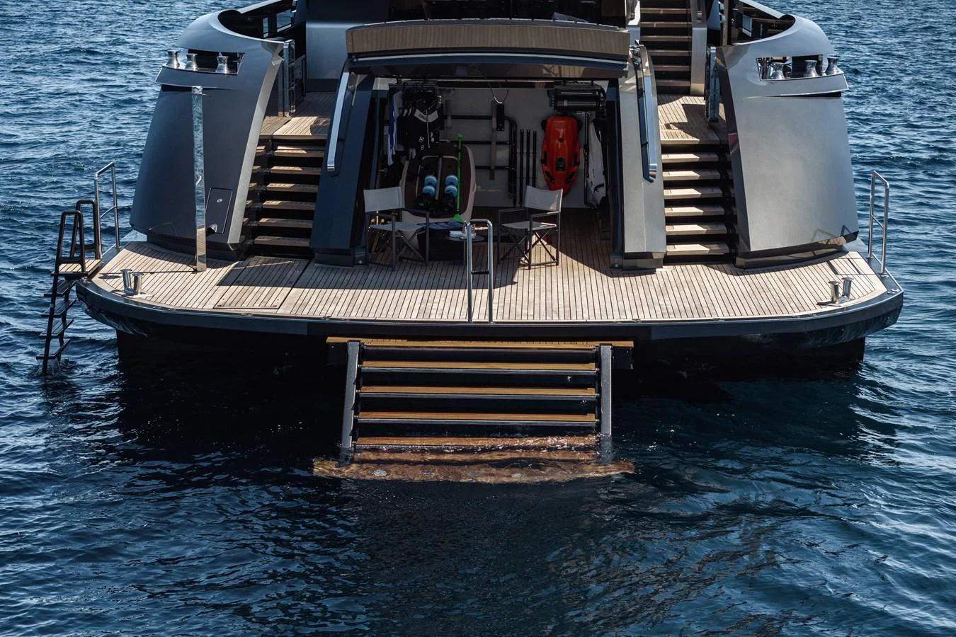 The yacht's aft deck features a spacious swim platform and inviting steps leading into the water. aboard FLYING DAGGER III Yacht for Sale