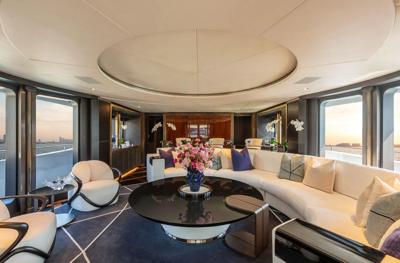 The yacht's salon features elegant furnishings and expansive windows offering stunning views. aboard ROCKET Yacht for Sale