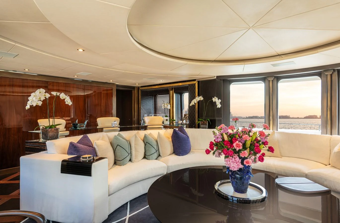 The salon features a luxurious seating area with elegant decor and large windows offering stunning views. aboard ROCKET Yacht for Sale