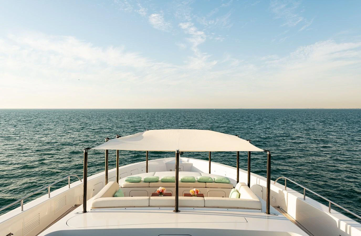 The yacht's flybridge offers a spacious and inviting area with comfortable seating under a canopy, perfect for enjoying the open sea views. aboard ROCKET Yacht for Sale
