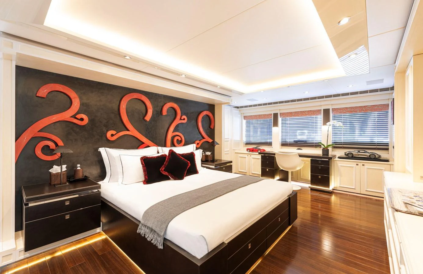 The master stateroom features a luxurious bed with modern decor and ample natural light. aboard ROCKET Yacht for Sale