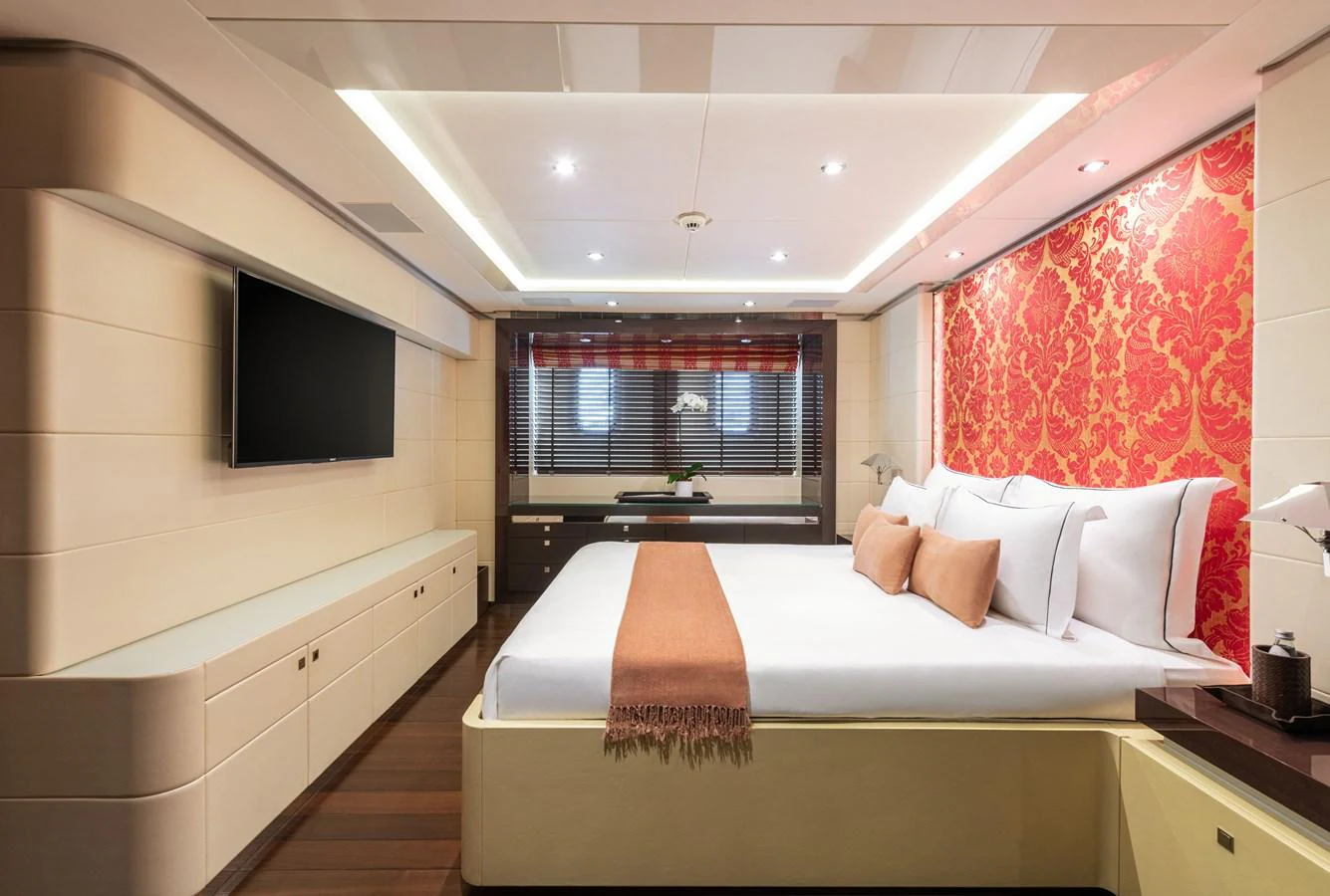 The master stateroom features a luxurious bed with elegant decor and ample storage space. aboard ROCKET Yacht for Sale