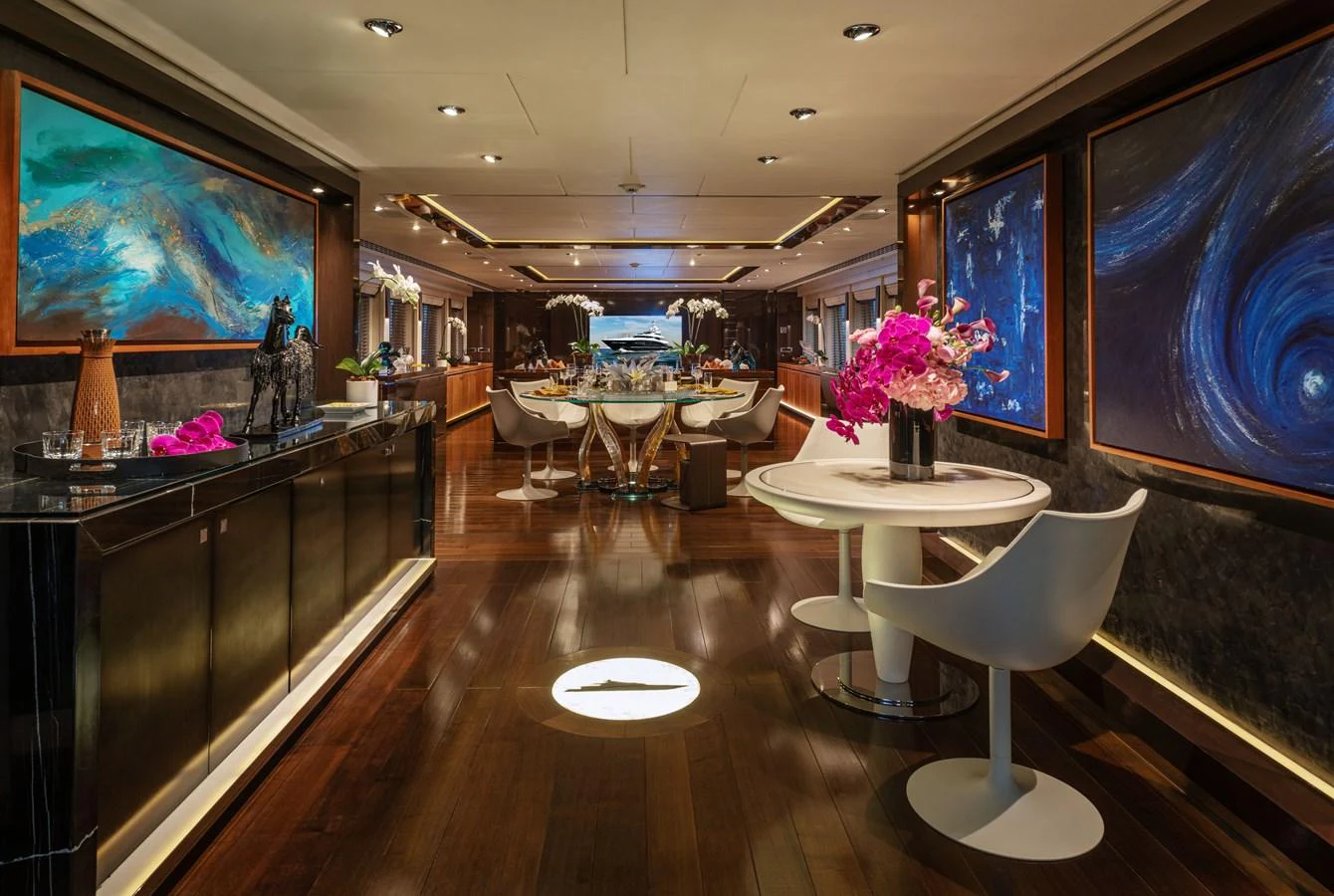 The luxurious dining area features elegant decor and ambient lighting, creating a sophisticated atmosphere for guests. aboard ROCKET Yacht for Sale
