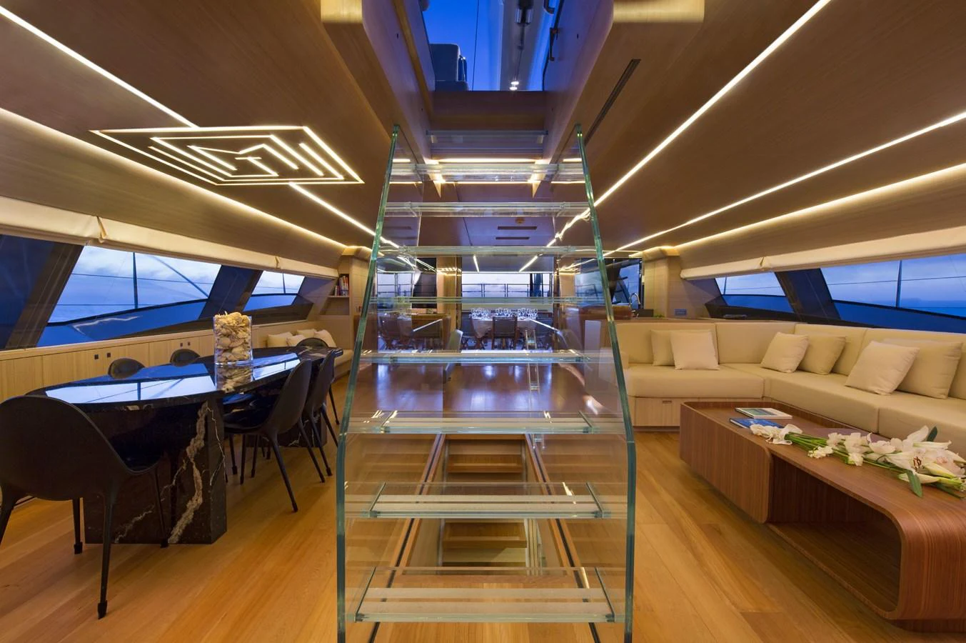 The yacht's salon features a modern design with ample seating and a stylish dining area. aboard OHANA Yacht for Sale