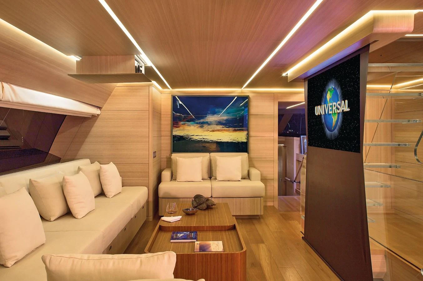 The yacht's salon features a cozy seating area with a large screen for entertainment. aboard OHANA Yacht for Sale