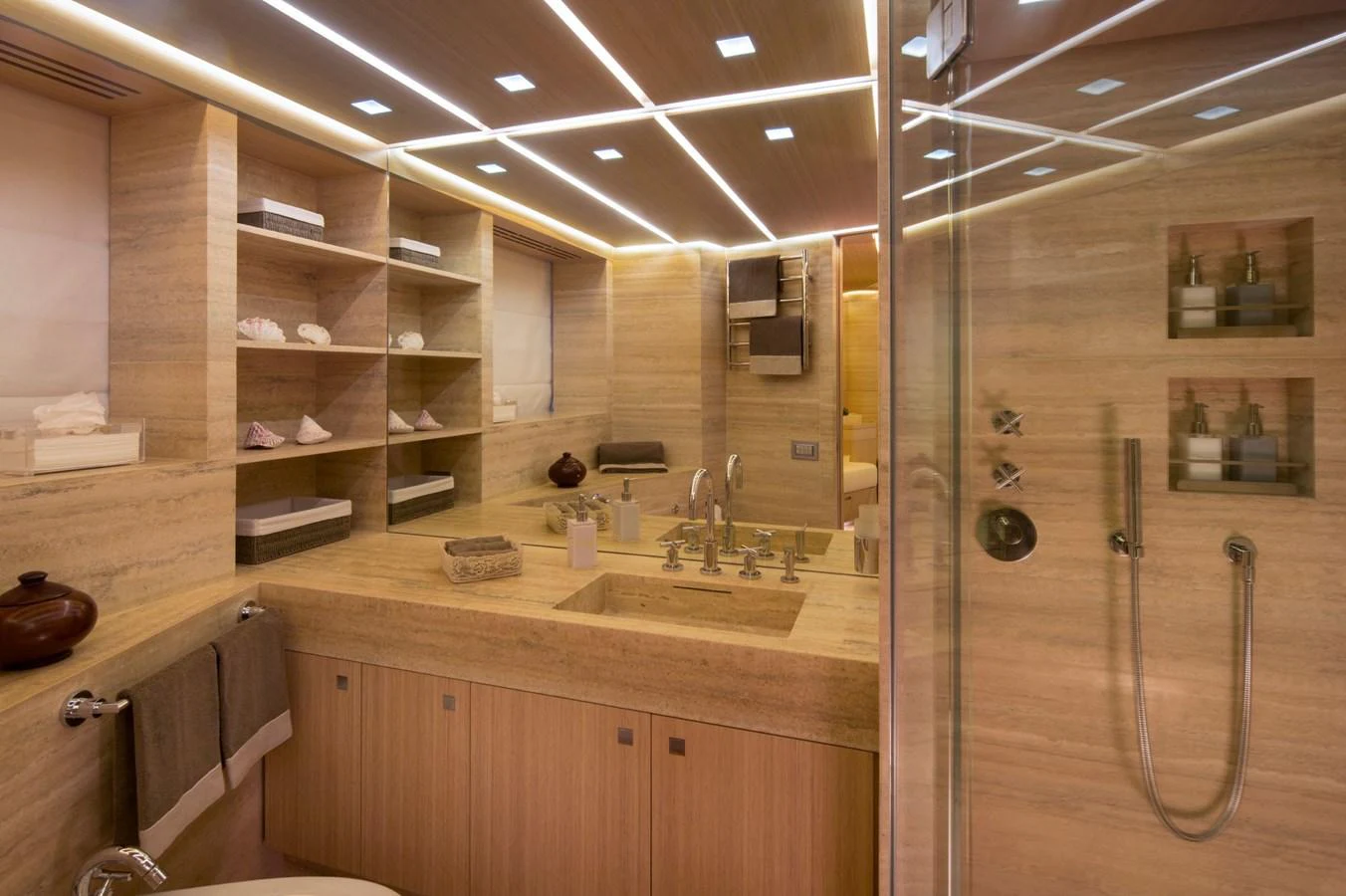 The yacht's bathroom features elegant wood finishes and modern fixtures, creating a luxurious and serene atmosphere. aboard OHANA Yacht for Sale