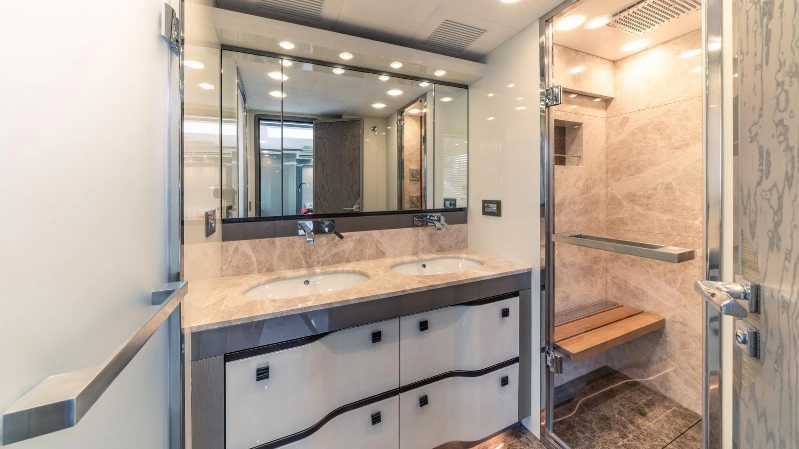 The yacht's bathroom features a double sink vanity and a spacious shower area with elegant marble finishes. aboard VIVALDI Yacht for Sale