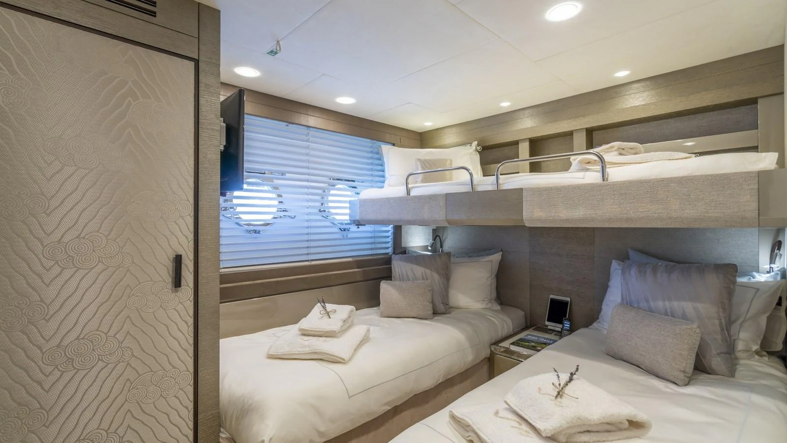 The guest stateroom features twin beds and a bunk, offering a cozy and comfortable sleeping area. aboard VIVALDI Yacht for Sale