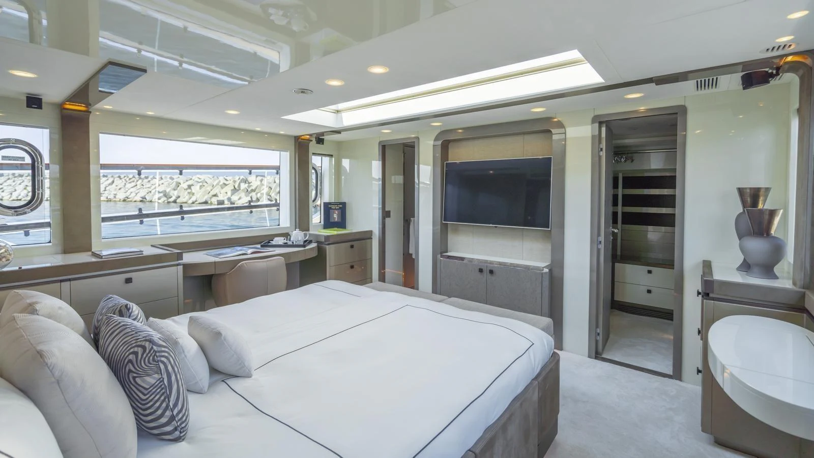 The master stateroom features a spacious bed, modern decor, and ample natural light. aboard VIVALDI Yacht for Sale