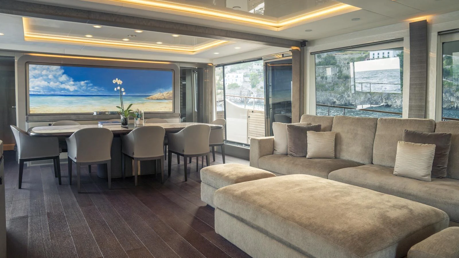 The yacht's salon features a spacious seating area with a large dining table and panoramic windows. aboard VIVALDI Yacht for Sale