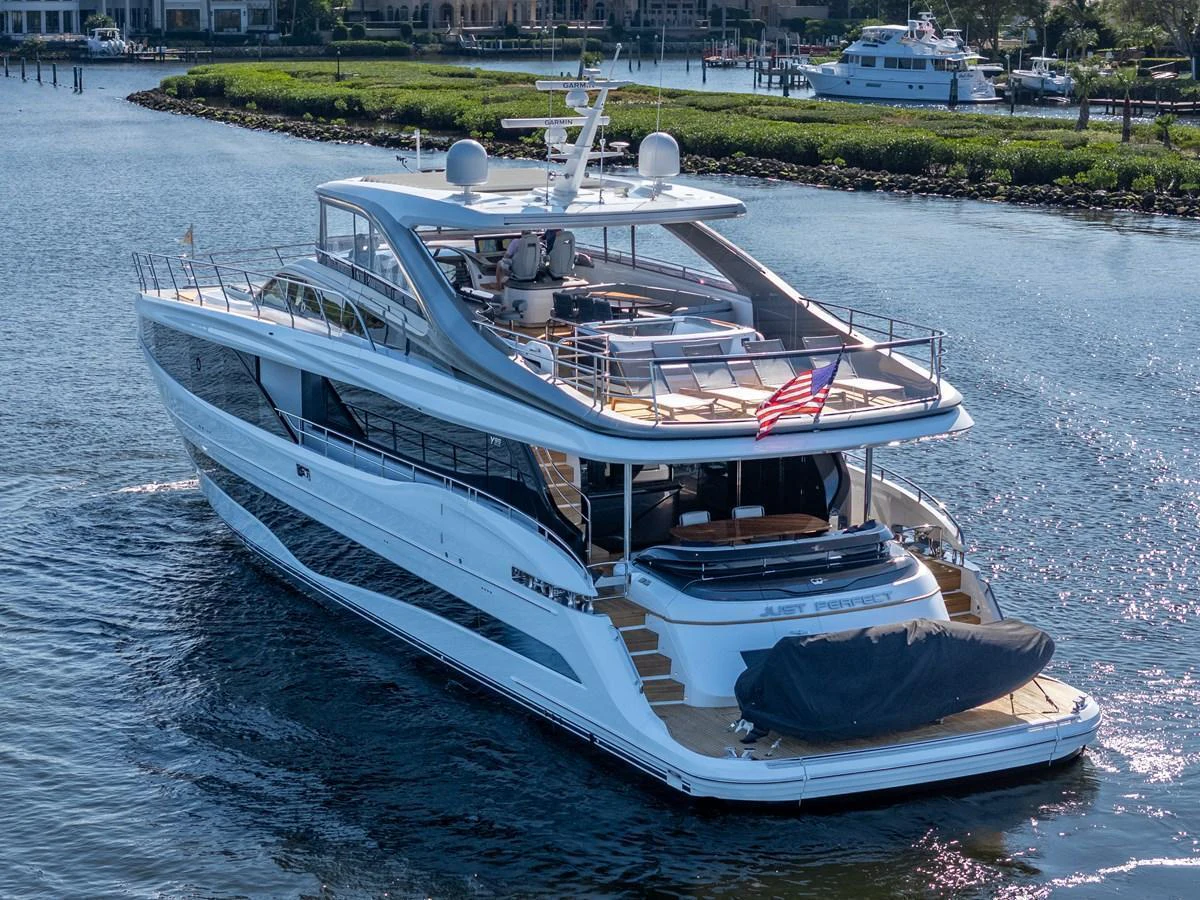 A sleek and modern yacht cruising on calm waters with an inviting aft deck and flybridge. aboard JUST PERFECT Yacht for Sale