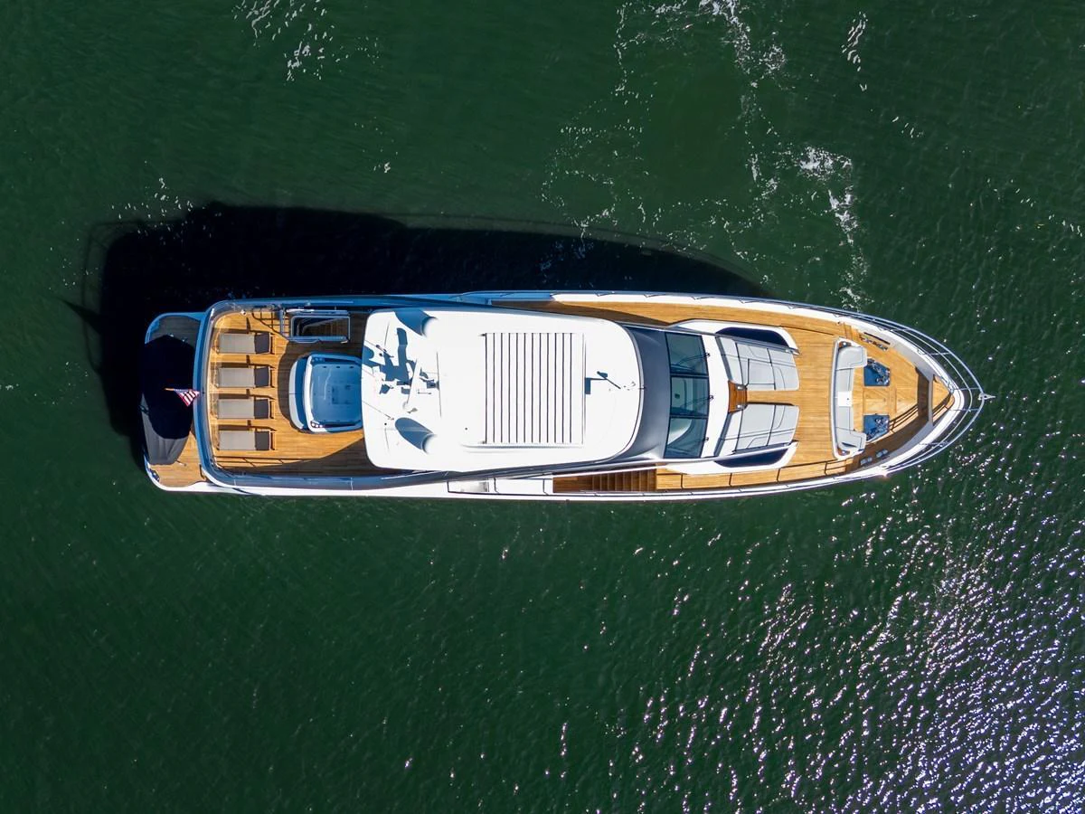 Aerial view of a sleek yacht cruising on calm waters. aboard JUST PERFECT Yacht for Sale