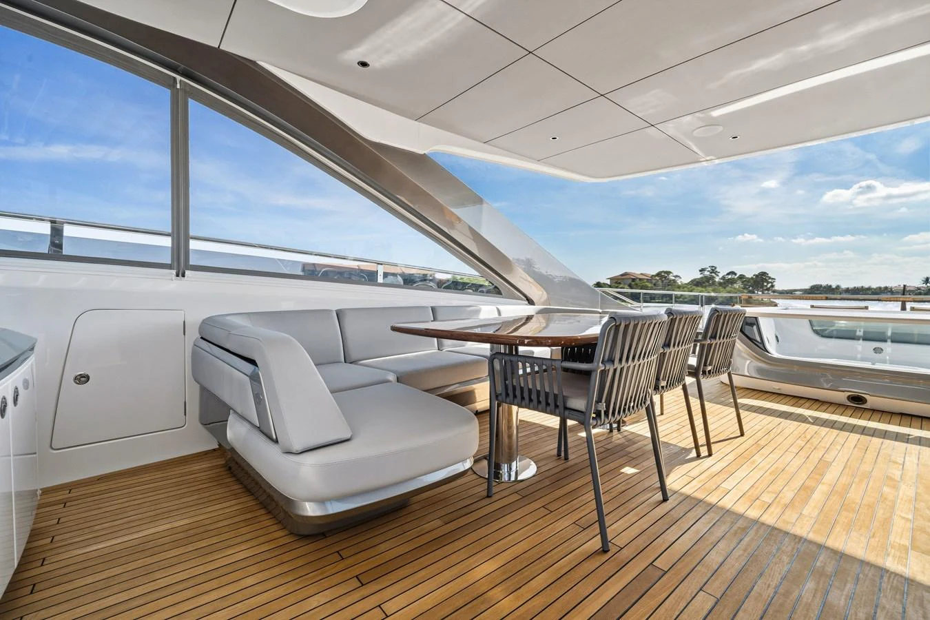 The aft deck features a stylish dining area with a sleek table and comfortable seating, perfect for alfresco meals. aboard JUST PERFECT Yacht for Sale