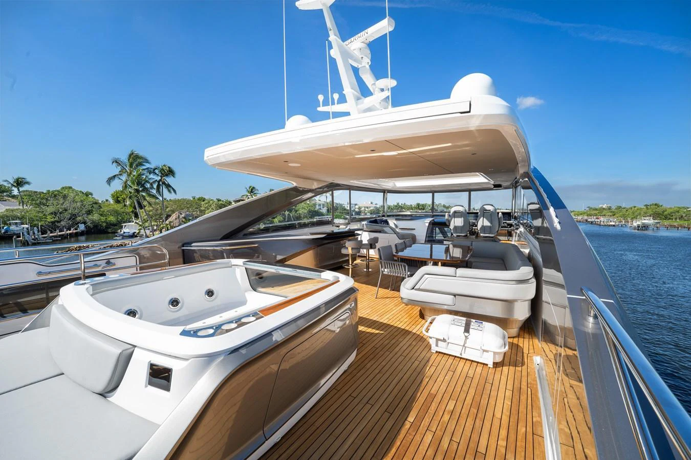 The flybridge offers a luxurious space with a hot tub, ample seating, and a stunning view of the water. aboard JUST PERFECT Yacht for Sale