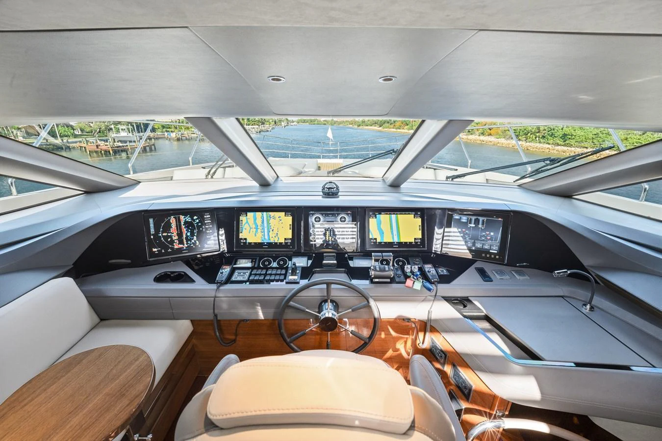 The helm station offers a panoramic view with advanced navigation equipment and luxurious seating. aboard JUST PERFECT Yacht for Sale