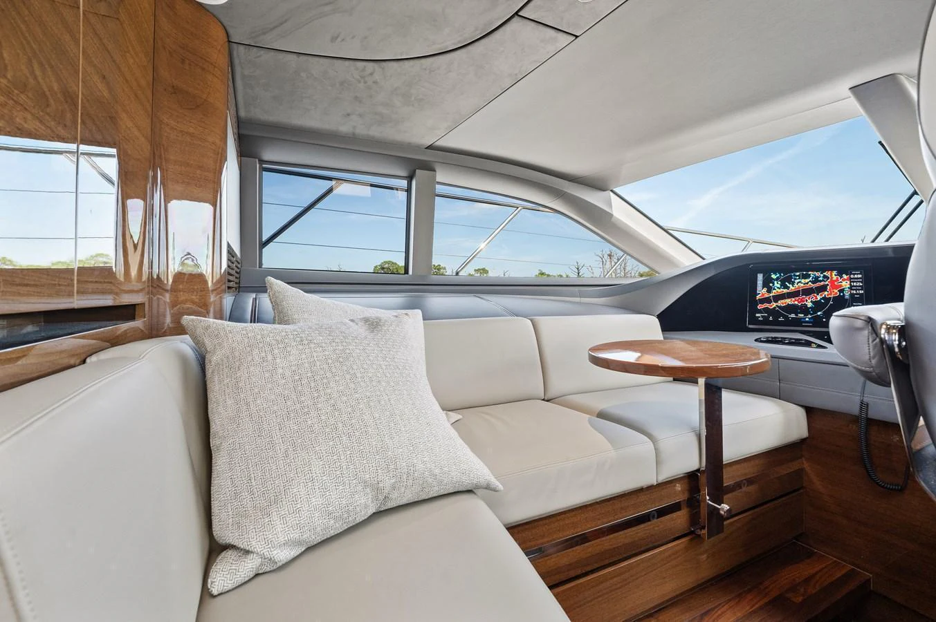 The salon features plush seating, a sleek wooden table, and modern design elements. aboard JUST PERFECT Yacht for Sale