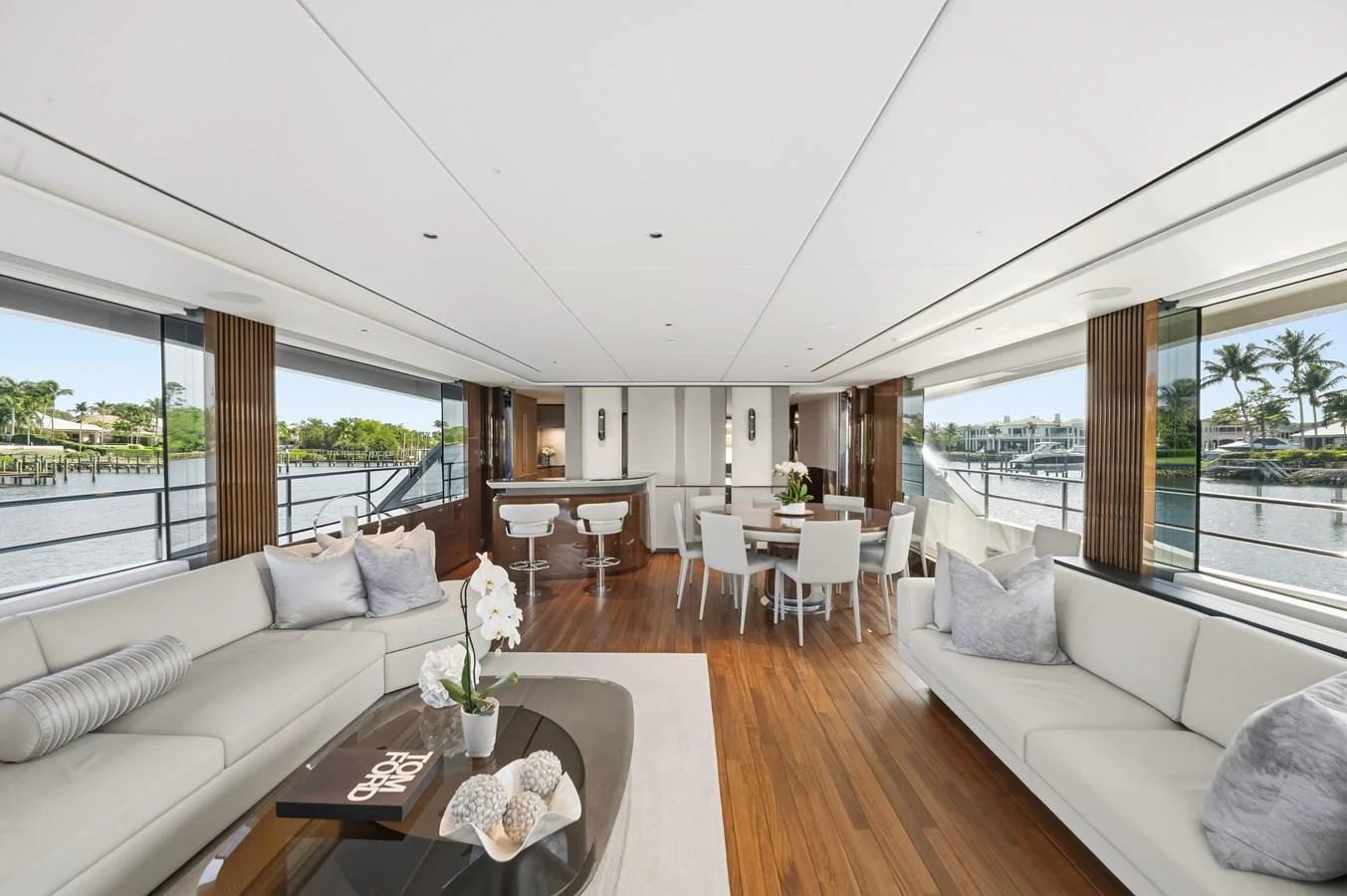 The yacht's salon features elegant seating, a dining area, and large windows offering panoramic views. aboard JUST PERFECT Yacht for Sale