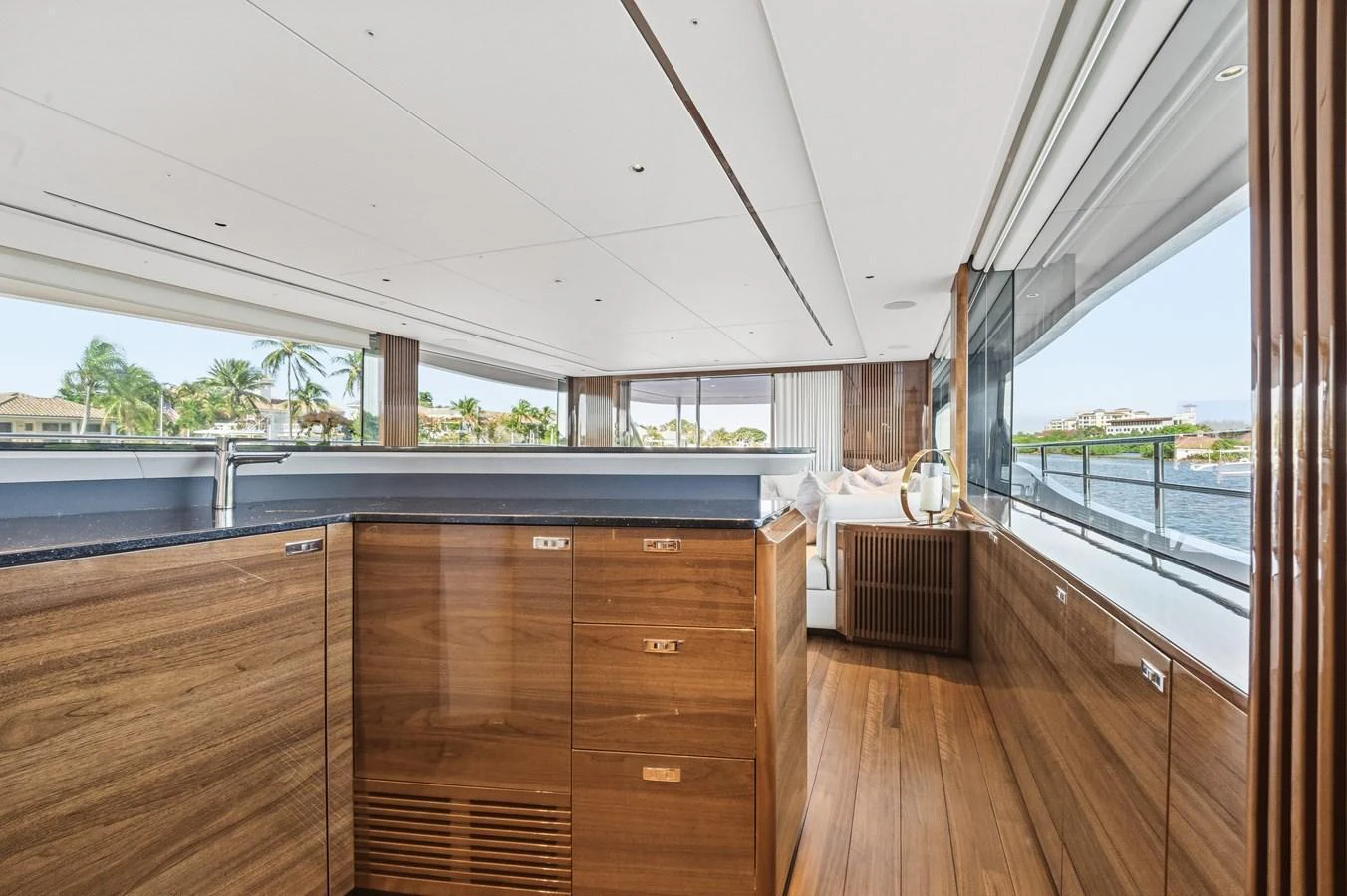 The yacht's interior features elegant wood finishes and expansive windows offering stunning views. aboard JUST PERFECT Yacht for Sale