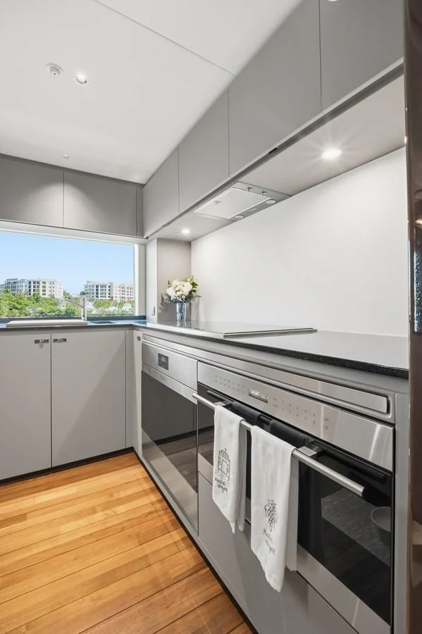 The modern galley features sleek cabinetry, high-end appliances, and a bright, airy atmosphere. aboard JUST PERFECT Yacht for Sale