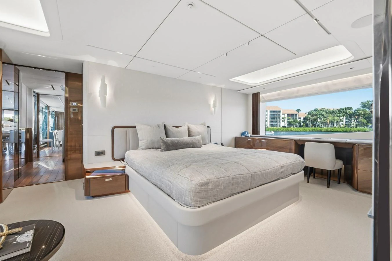 The master stateroom features a luxurious bed with a scenic view through a large window. aboard JUST PERFECT Yacht for Sale