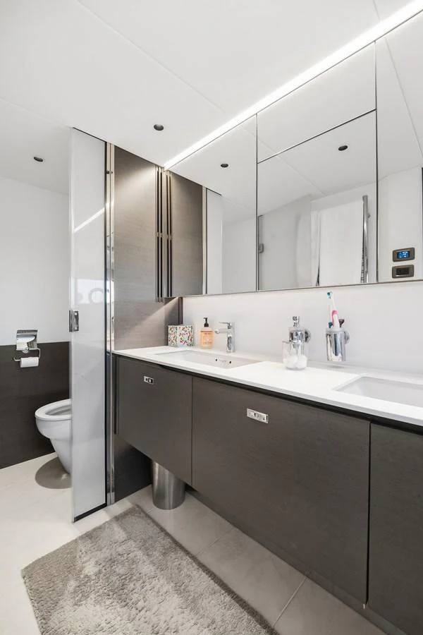 The bathroom features modern fixtures and a sleek design with ample storage space. aboard JUST PERFECT Yacht for Sale