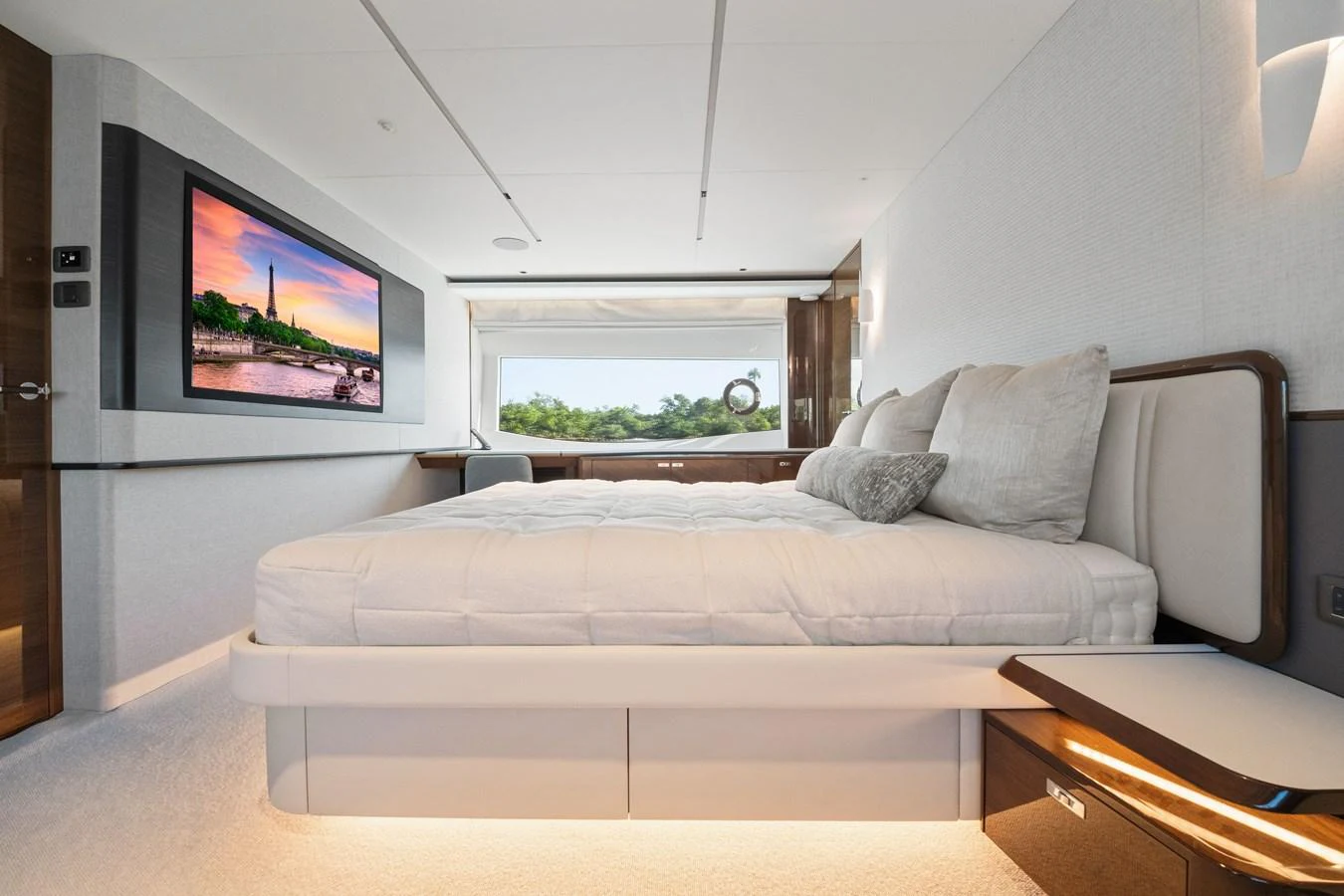 A luxurious stateroom featuring a large bed, modern decor, and a flat-screen TV. aboard JUST PERFECT Yacht for Sale