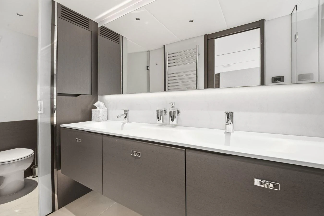 A sleek and modern yacht bathroom with dual sinks and contemporary fixtures. aboard JUST PERFECT Yacht for Sale