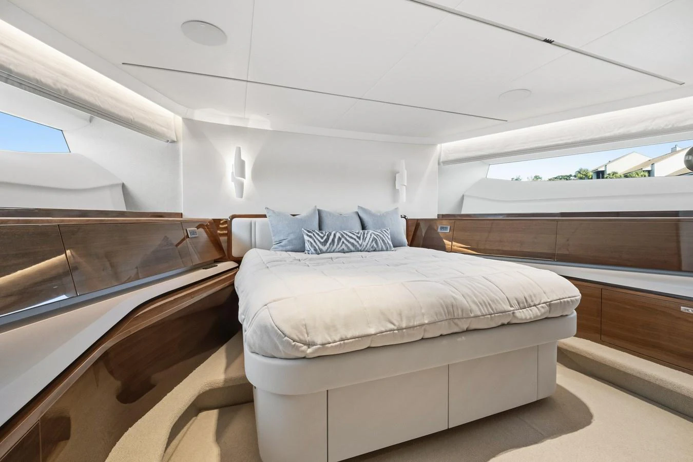 A luxurious stateroom featuring a plush bed and elegant wooden accents. aboard JUST PERFECT Yacht for Sale