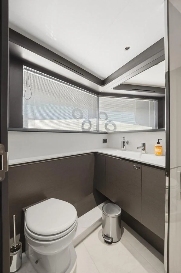 A sleek and modern yacht bathroom with contemporary fixtures and ample natural light. aboard JUST PERFECT Yacht for Sale
