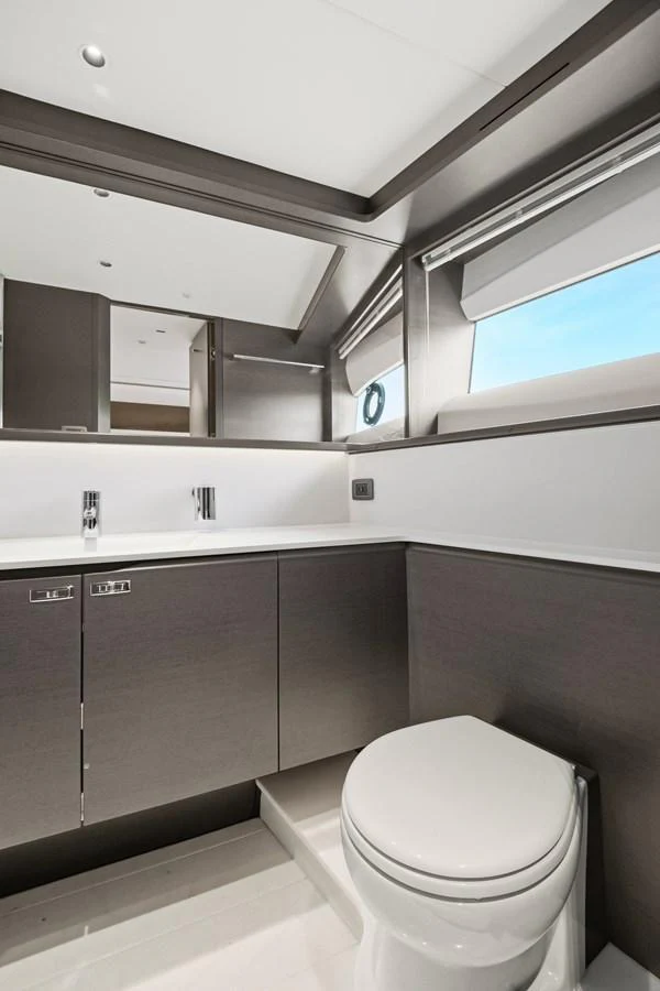 A sleek and modern yacht bathroom with contemporary fixtures and ample natural light. aboard JUST PERFECT Yacht for Sale