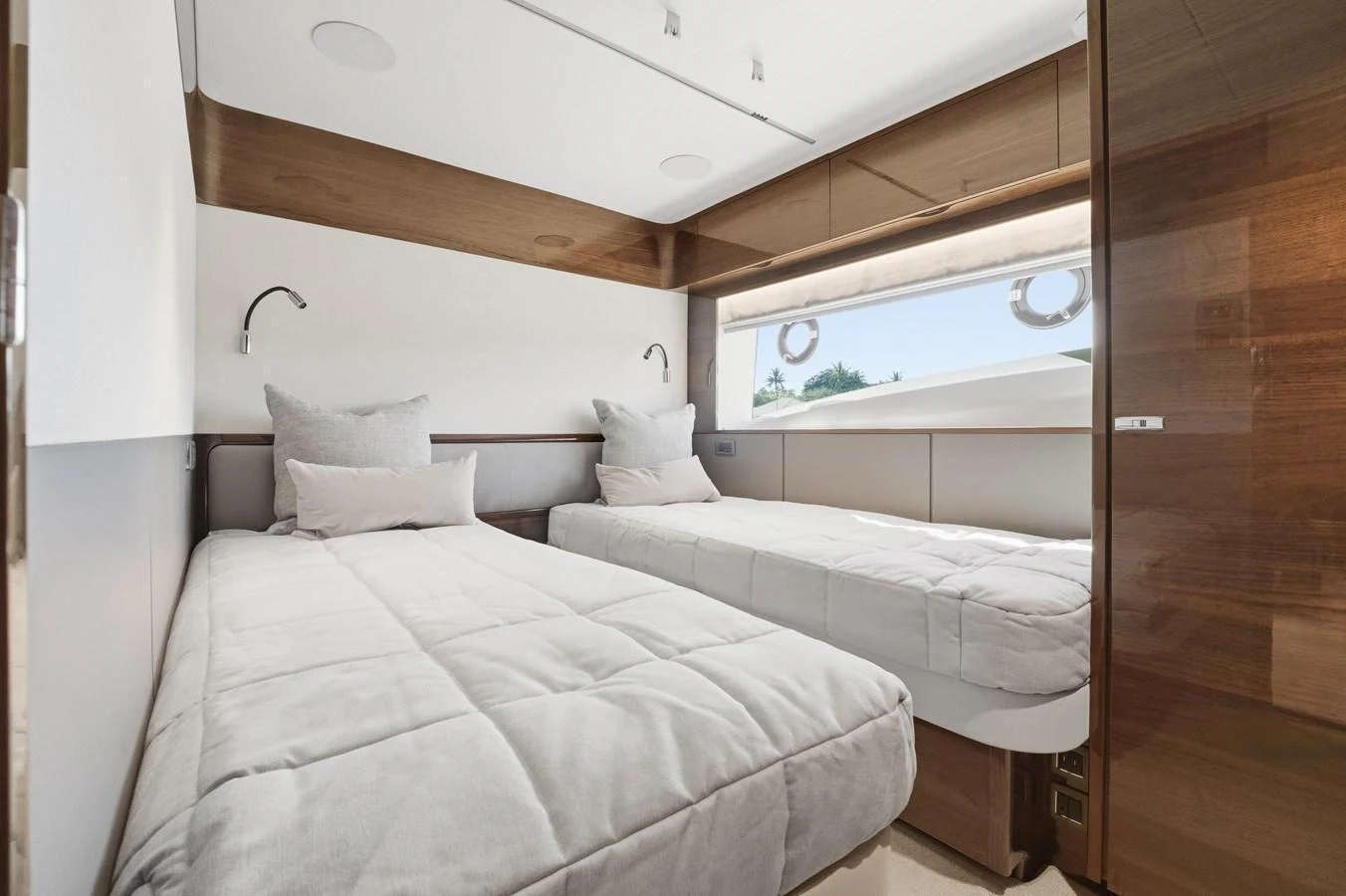 The guest stateroom features twin beds with plush bedding and modern wooden accents. aboard JUST PERFECT Yacht for Sale