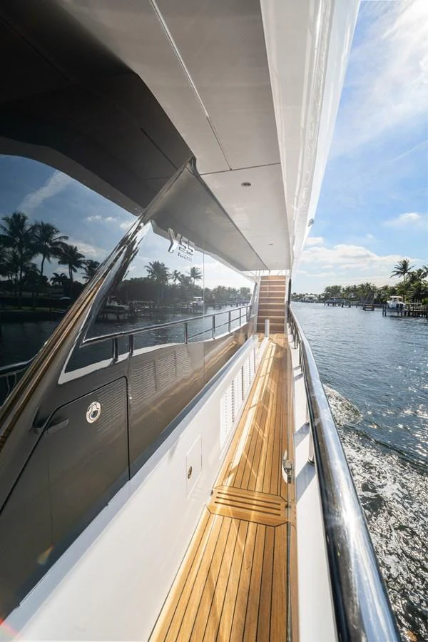 A sleek side deck with polished wood flooring and a view of the water. aboard JUST PERFECT Yacht for Sale