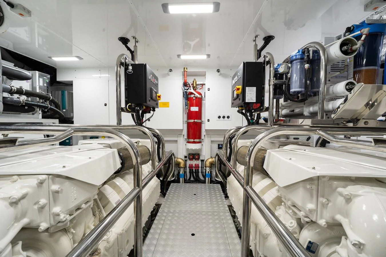The image showcases a pristine engine room with well-organized machinery and equipment. aboard JUST PERFECT Yacht for Sale