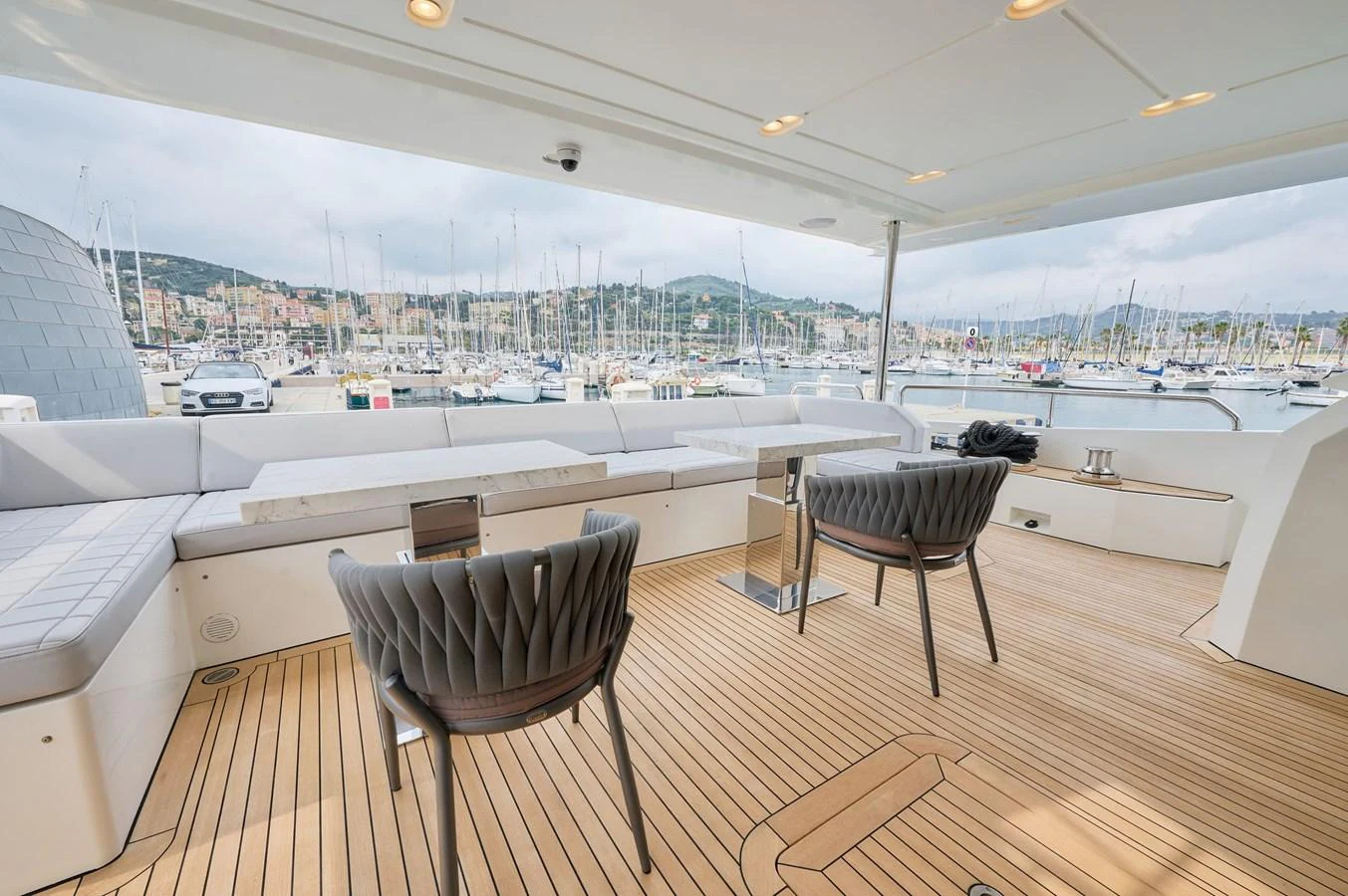The aft deck offers a spacious and inviting area with comfortable seating and a beautiful view of the marina. aboard SUN & SEA Yacht for Sale