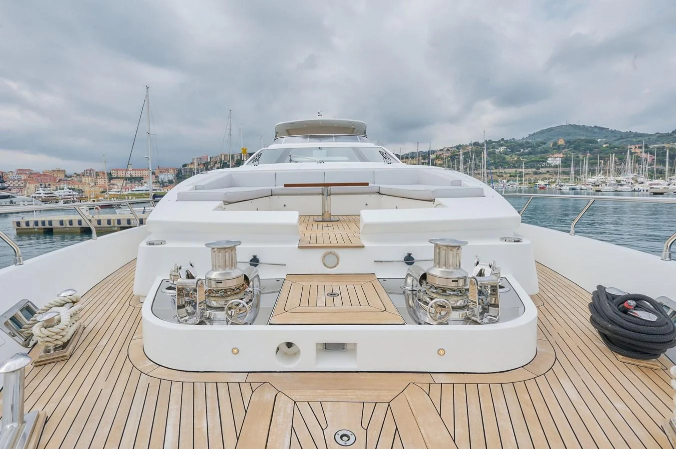 The foredeck of the yacht features a spacious lounging area with a beautiful view of the marina. aboard SUN & SEA Yacht for Sale