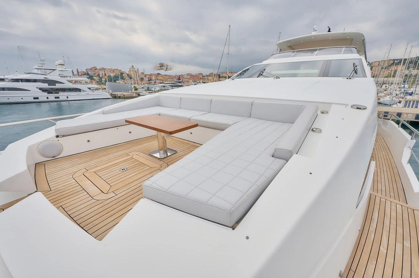 The foredeck features a spacious sunbathing area with plush seating and a small table, perfect for relaxation. aboard SUN & SEA Yacht for Sale