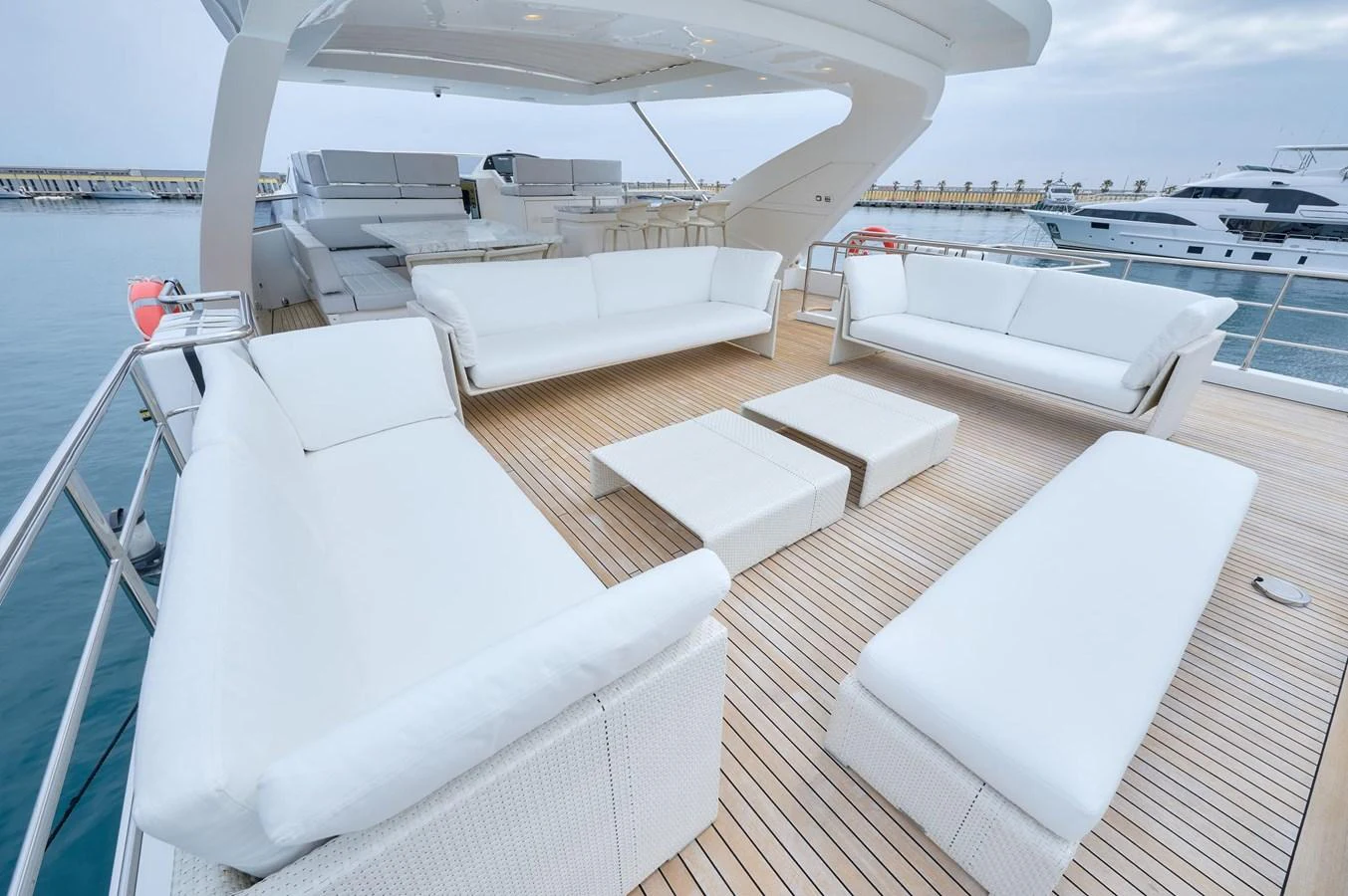 The aft deck features luxurious white seating arrangements with a spacious and inviting layout. aboard SUN & SEA Yacht for Sale