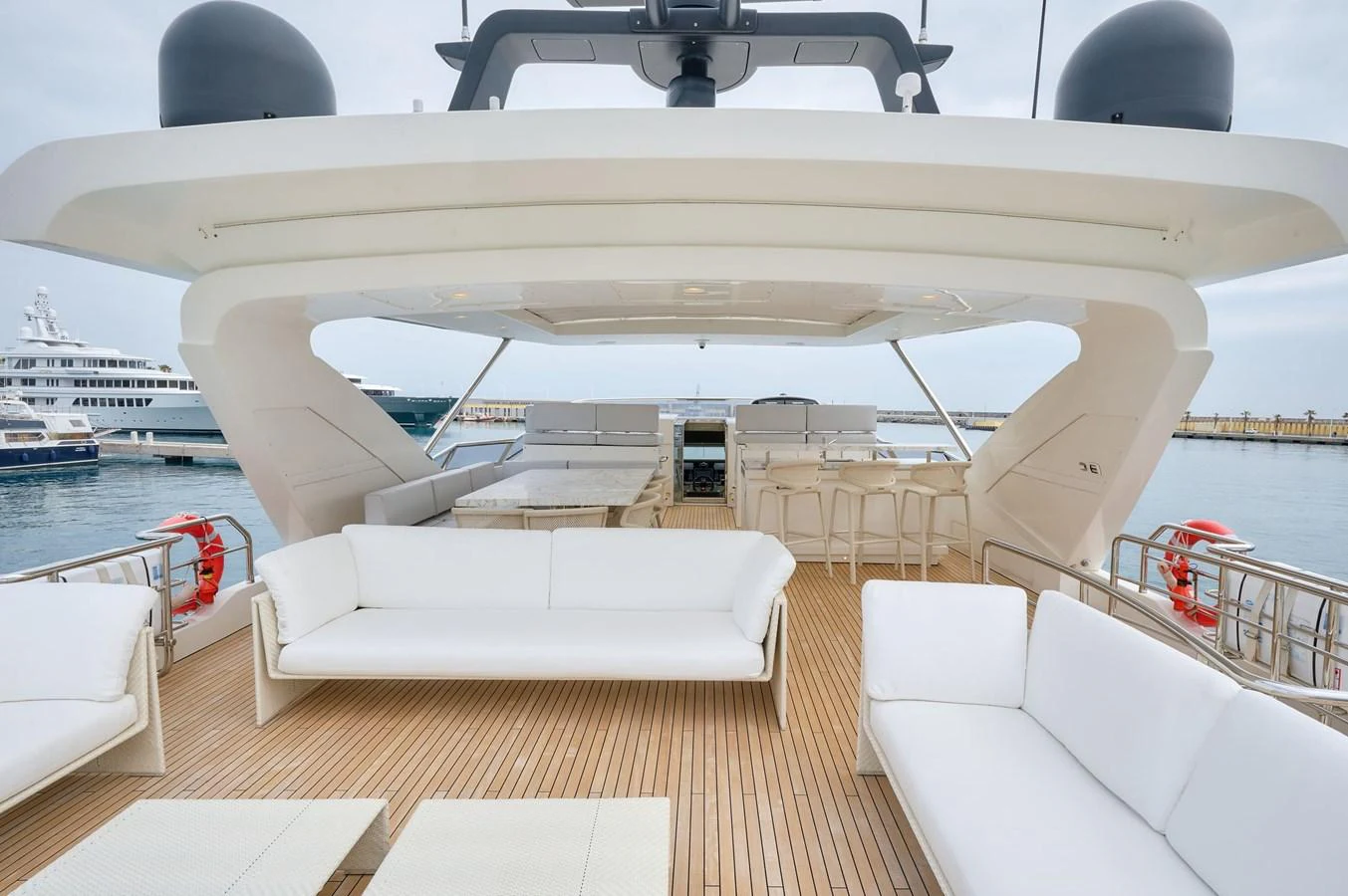 The spacious flybridge offers ample seating and lounging areas with a sleek, modern design. aboard SUN & SEA Yacht for Sale
