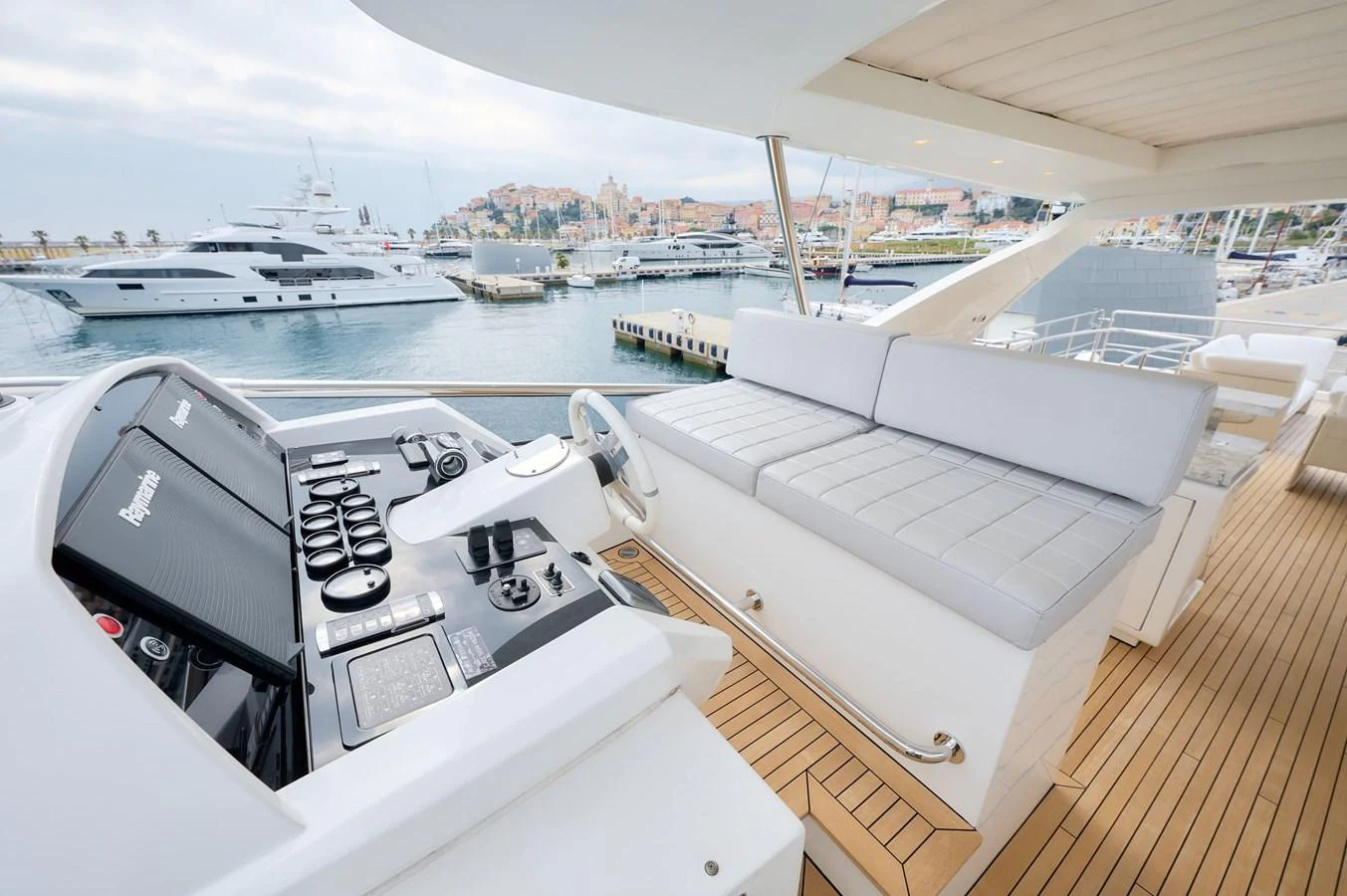 The flybridge offers a spacious seating area with a view of the marina. aboard SUN & SEA Yacht for Sale