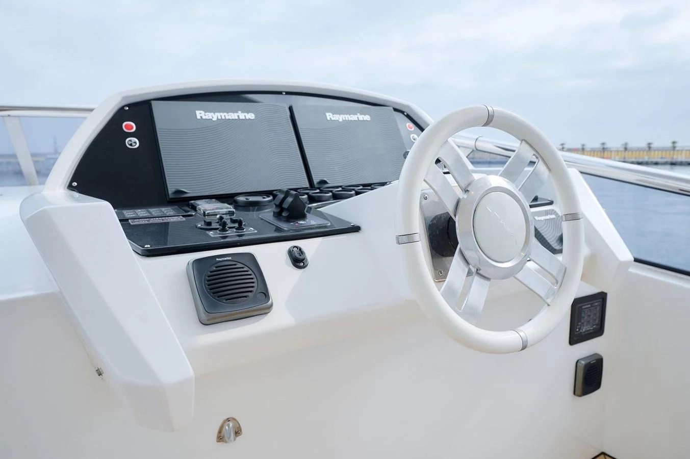 The helm station features advanced navigation equipment and a sleek steering wheel. aboard SUN & SEA Yacht for Sale