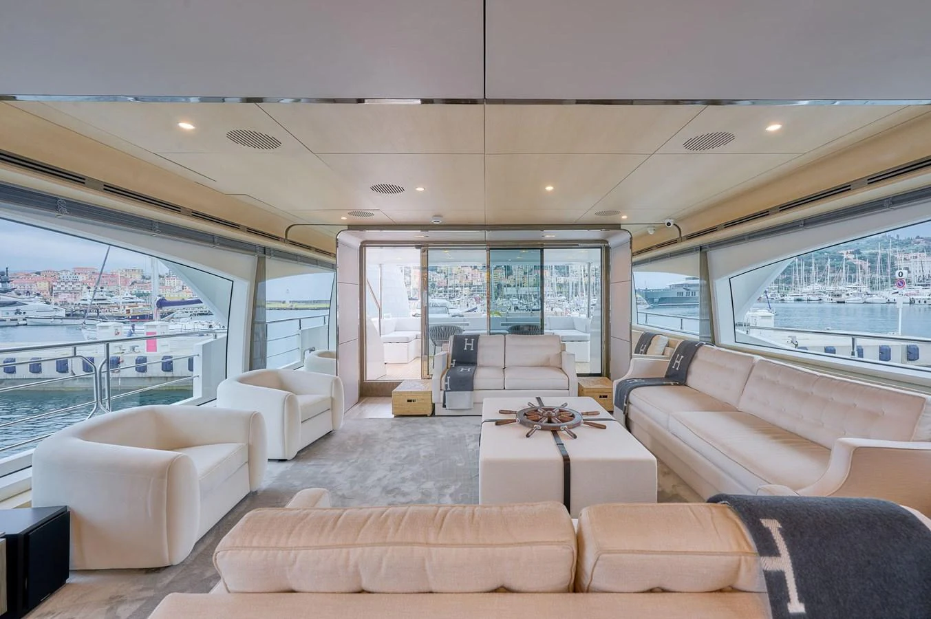 The salon offers a spacious and luxurious seating area with panoramic views of the marina. aboard SUN & SEA Yacht for Sale