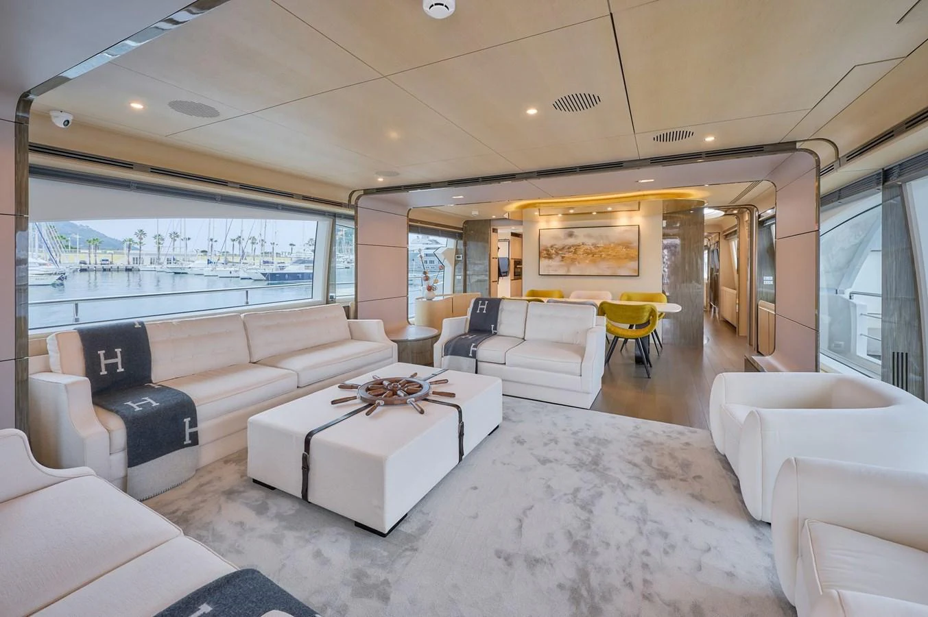 The salon features luxurious seating with a modern, open layout and large windows offering stunning marina views. aboard SUN & SEA Yacht for Sale