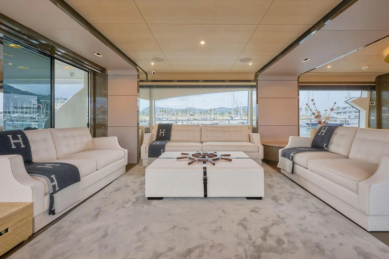The salon features plush seating and expansive windows offering panoramic views. aboard SUN & SEA Yacht for Sale