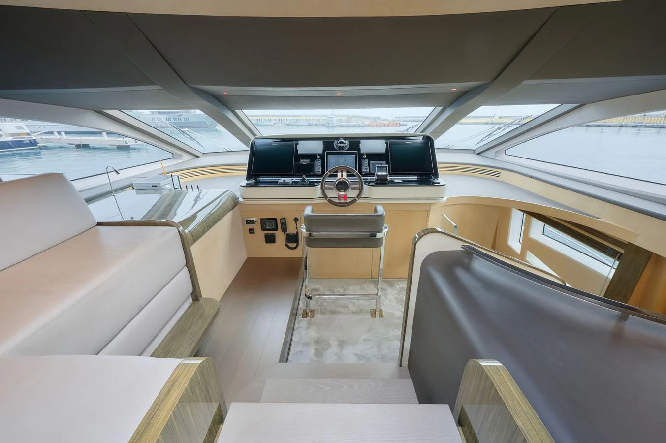 The helm station features modern navigation equipment and a comfortable seating area with panoramic views. aboard SUN & SEA Yacht for Sale