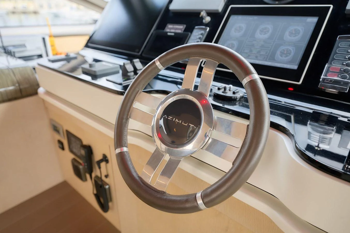 The helm station features a sleek steering wheel and advanced navigation controls. aboard SUN & SEA Yacht for Sale