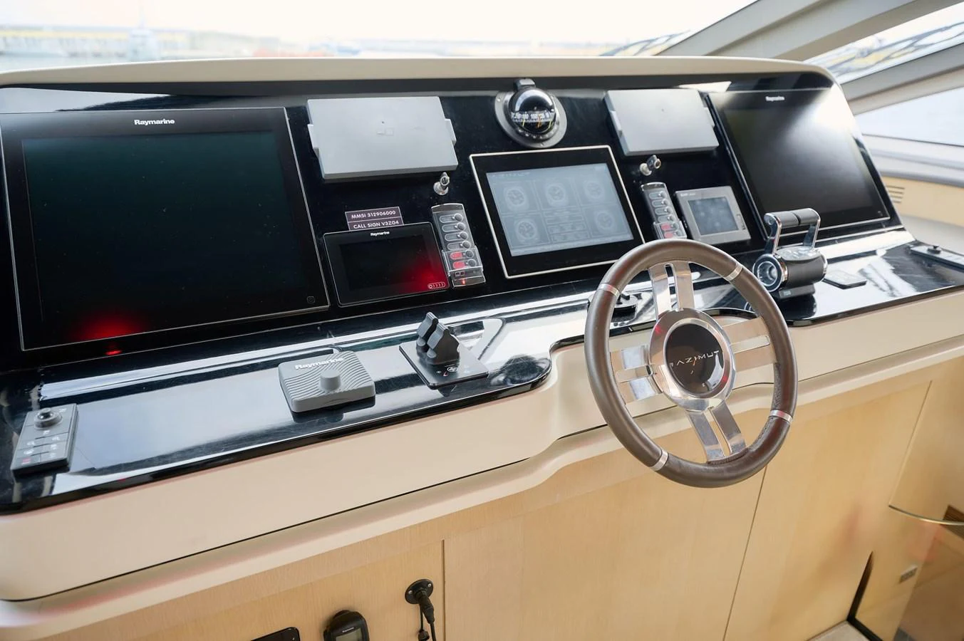 The helm station features advanced navigation equipment and a sleek steering wheel. aboard SUN & SEA Yacht for Sale