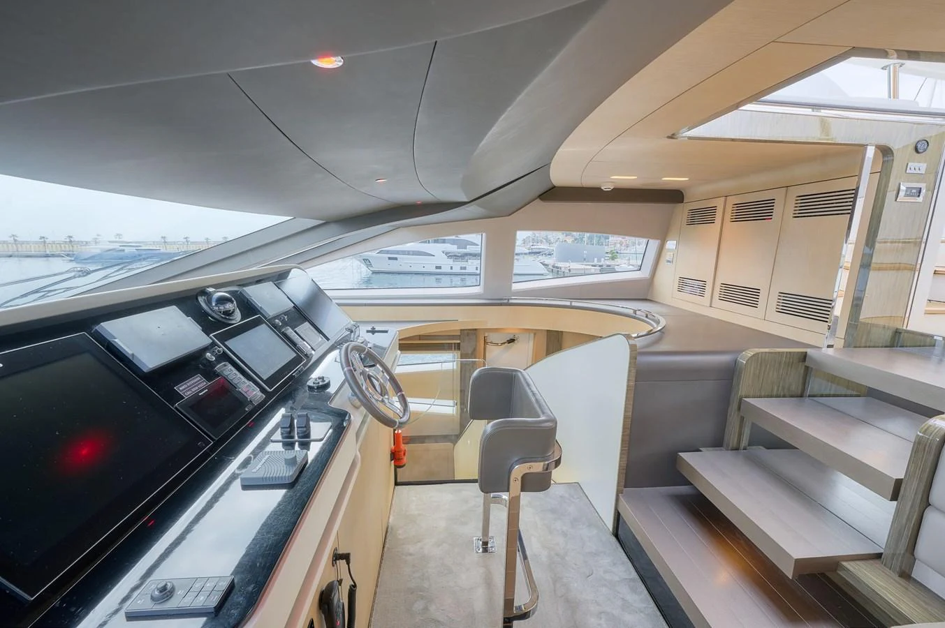 The helm station features modern navigation equipment and a sleek design with ample natural light. aboard SUN & SEA Yacht for Sale