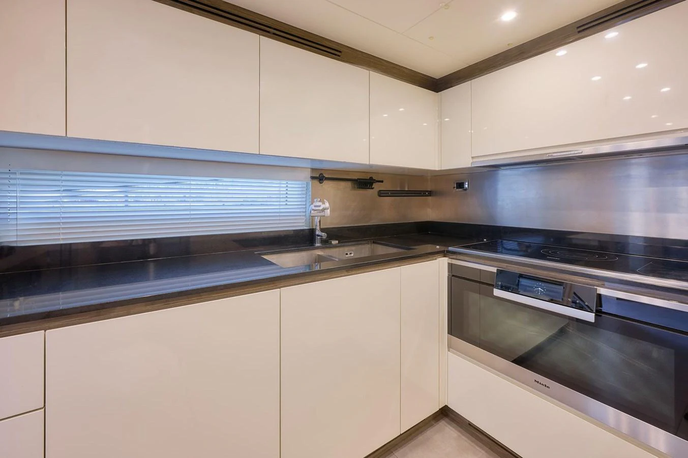 The yacht's galley features sleek, modern cabinetry and high-end appliances. aboard SUN & SEA Yacht for Sale