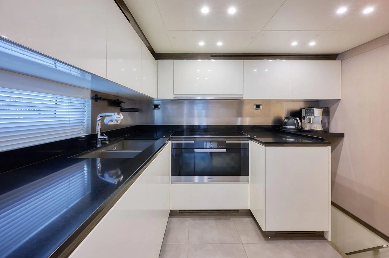 The yacht's galley is sleek and modern, featuring high-end appliances and ample counter space. aboard SUN & SEA Yacht for Sale
